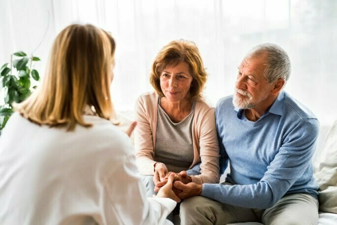 Pain Management - couple speaking with doctor