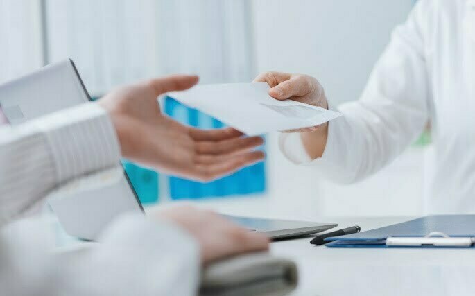 doctorHandingPaper Cervical Radiofrequency Neurotomy - doctor handing over paper to patient