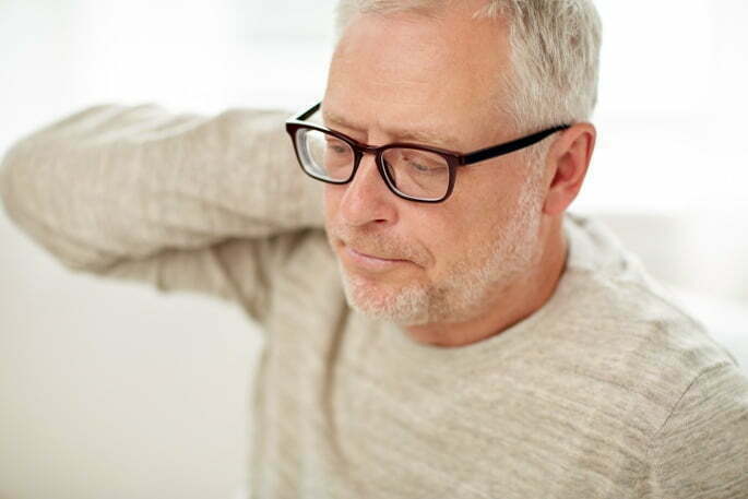 neckAche Stellate Ganglion Block - man holding the back of his neck