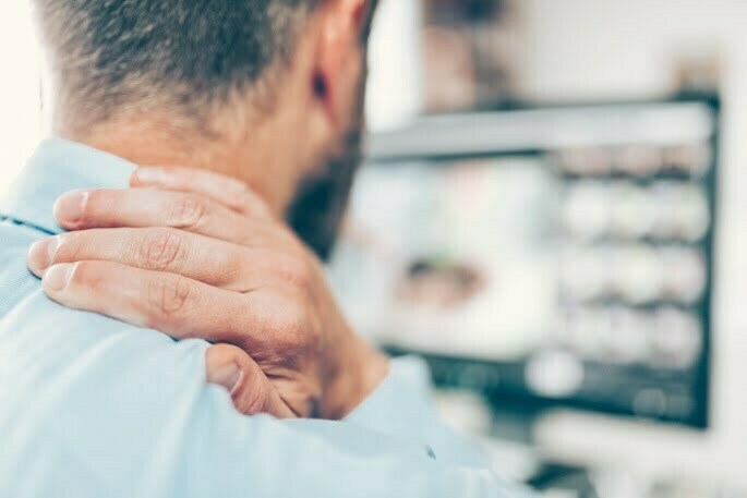 neckPainOffice joint injection - man with hand on neck having neck and back pain