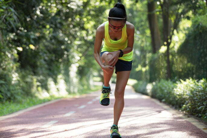 Female runner suffering with pain on sports running knee injury Joint Injection - lady hurt leg on run