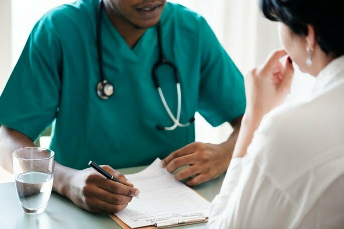 Pain Management - couple speaking with doctor
