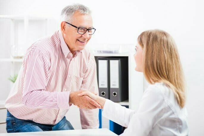 Pain Management - couple shaking hands with doctor