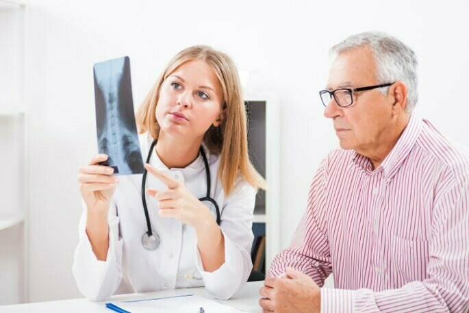 Pain Conditions We Treat - doctor showing patient an x ray