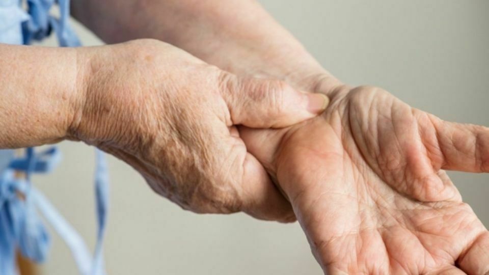 A Person Suffering from Wrist Pain Needs Herniatied Disc Treatment in Chicago, IL Cervical Disc Herniation - holding wrist
