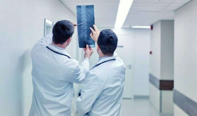 Spondylolisthesis - two doctors looking at x-ray