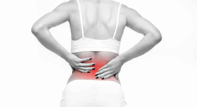 Degenerative Disc Disease - woman holding her lower back in pain