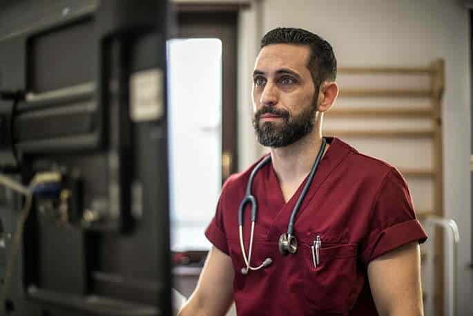 Doctor Working on Computer